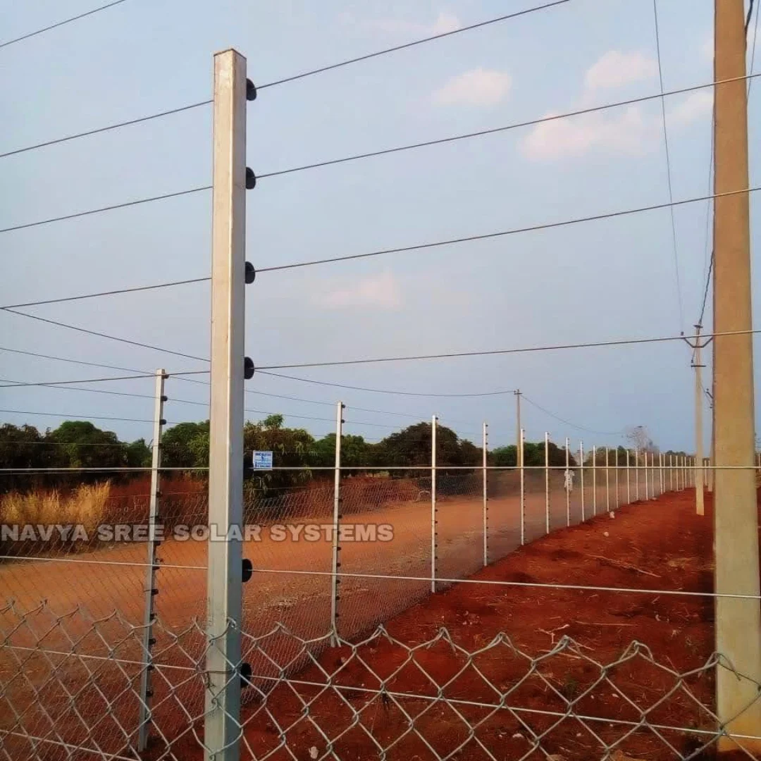 Chain link fence with solar fencing installed along open land