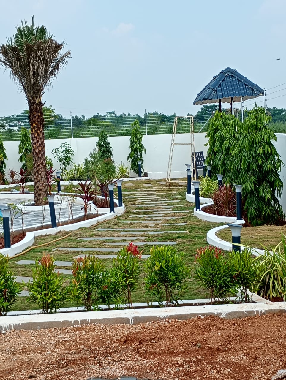 Garden compound wall with solar fencing installed at farmhouse