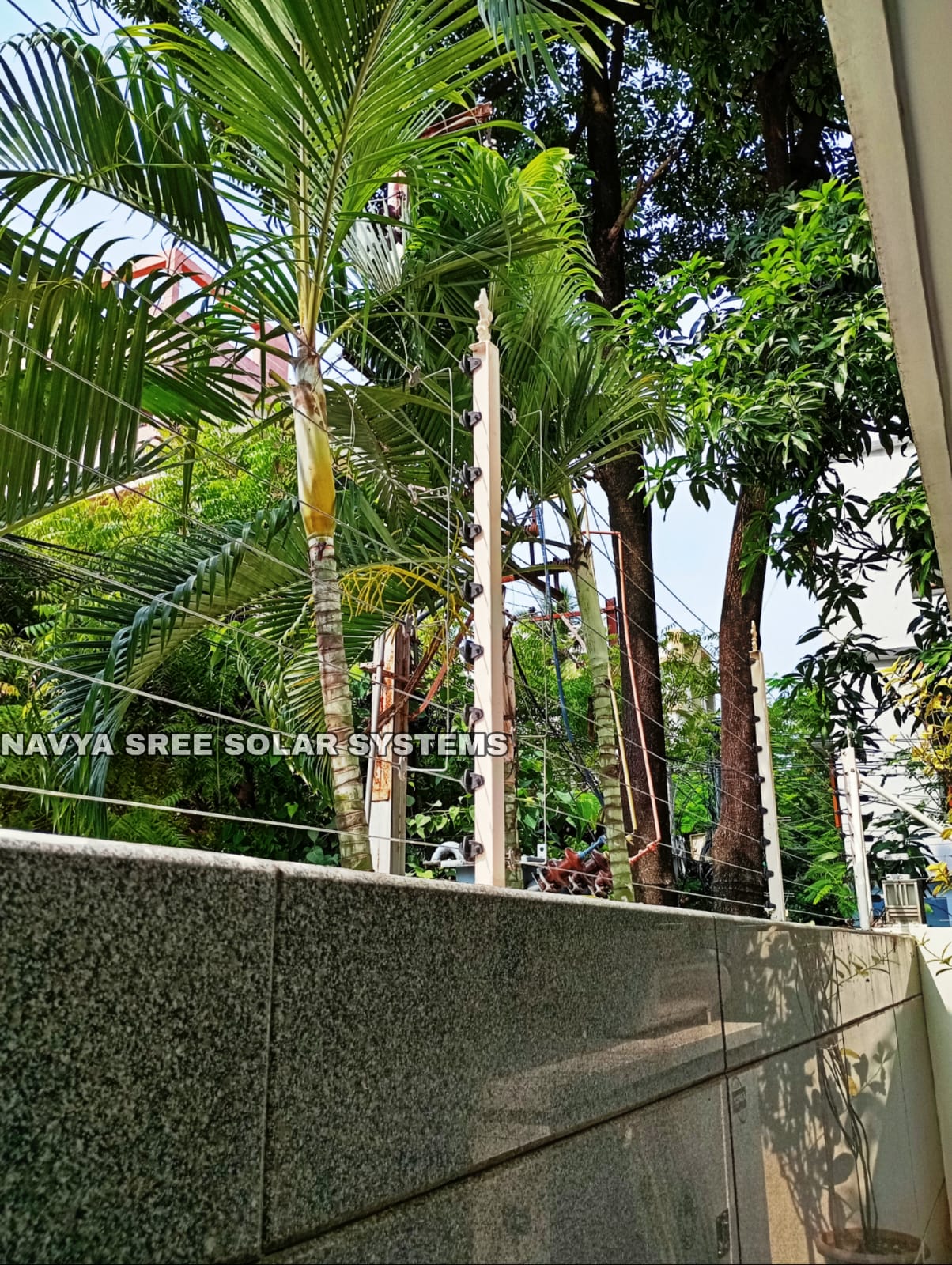 Residential compound wall with solar fence posts and wiring