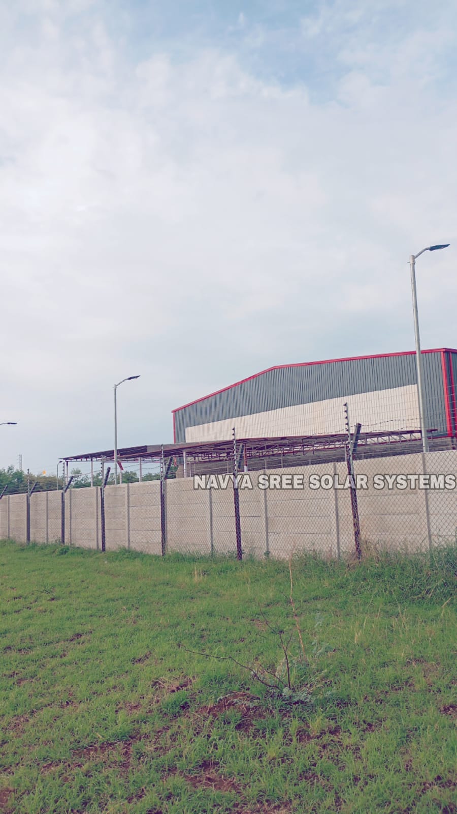 Industrial facility boundary wall with solar fencing