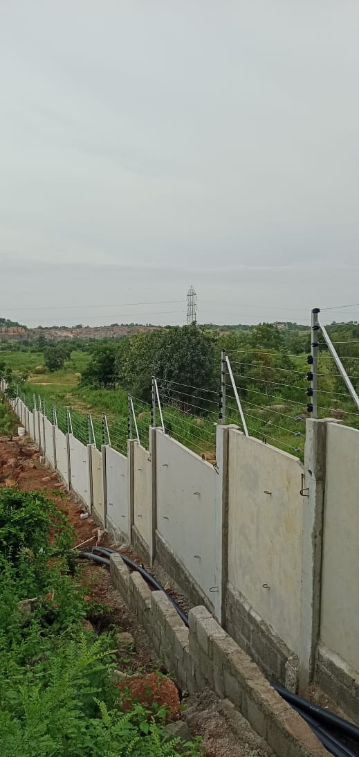 Boundary wall with solar fencing along hillside property