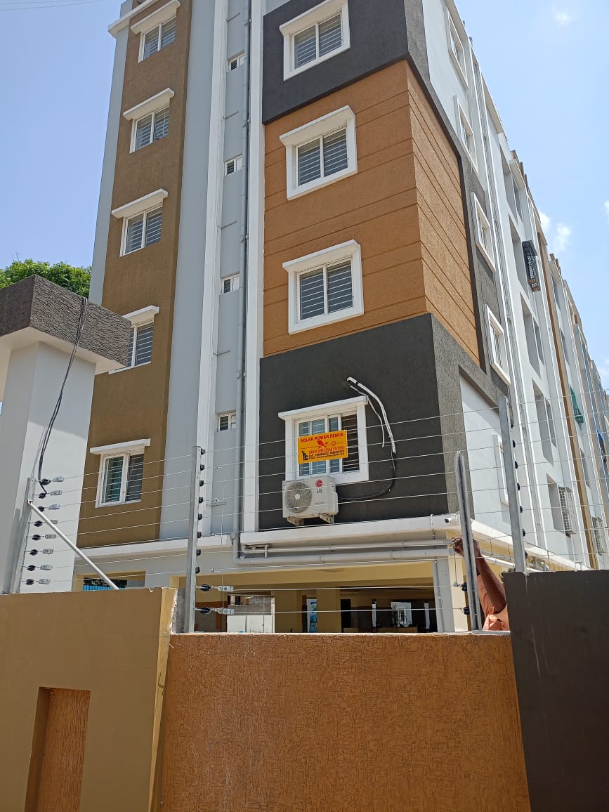 Residential apartment building protected with solar power fence